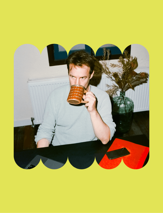 Team member taking sip of a drink from a coffee cup