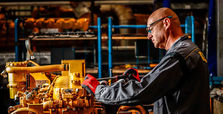 Pon mechanic working on a machine