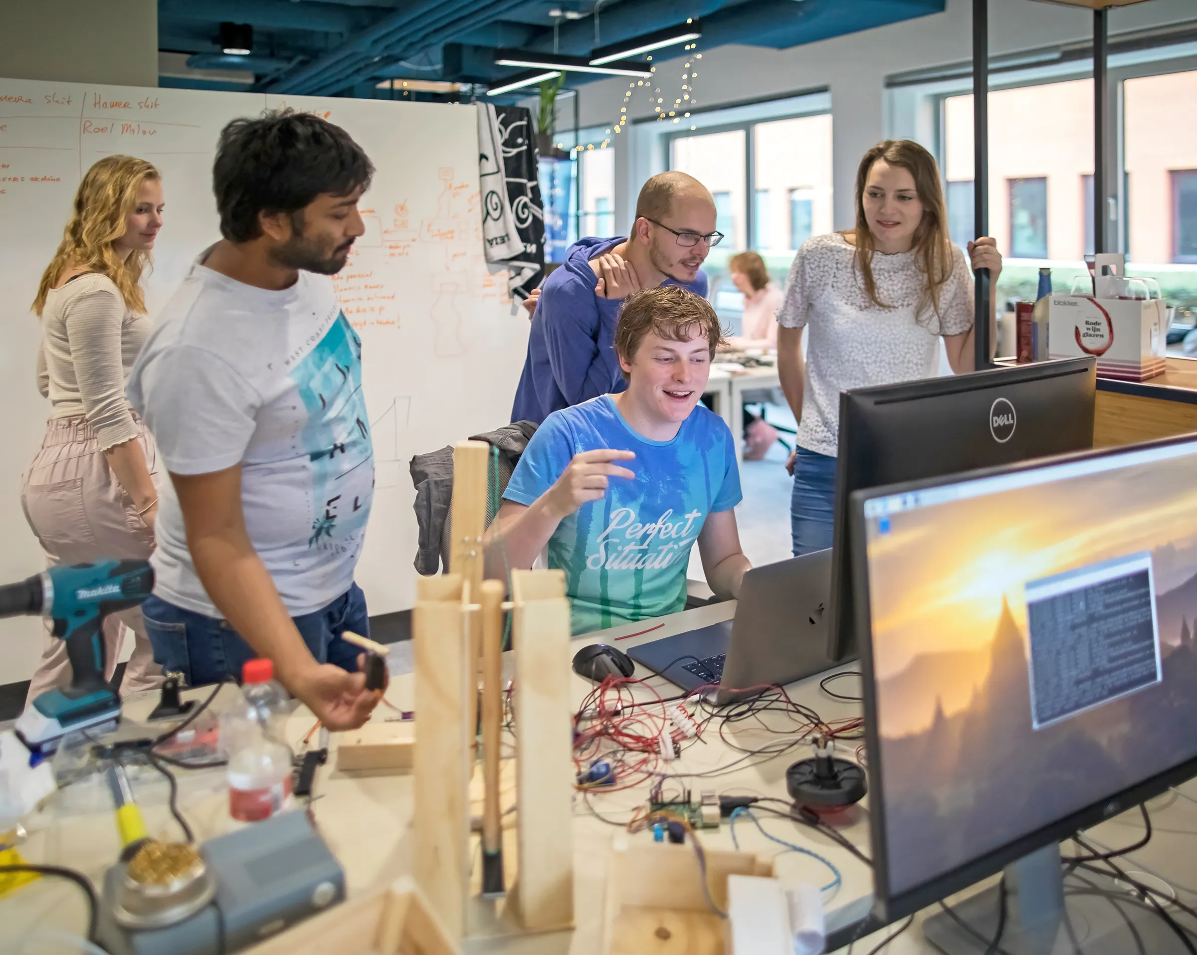 Group of developers behind a screen.