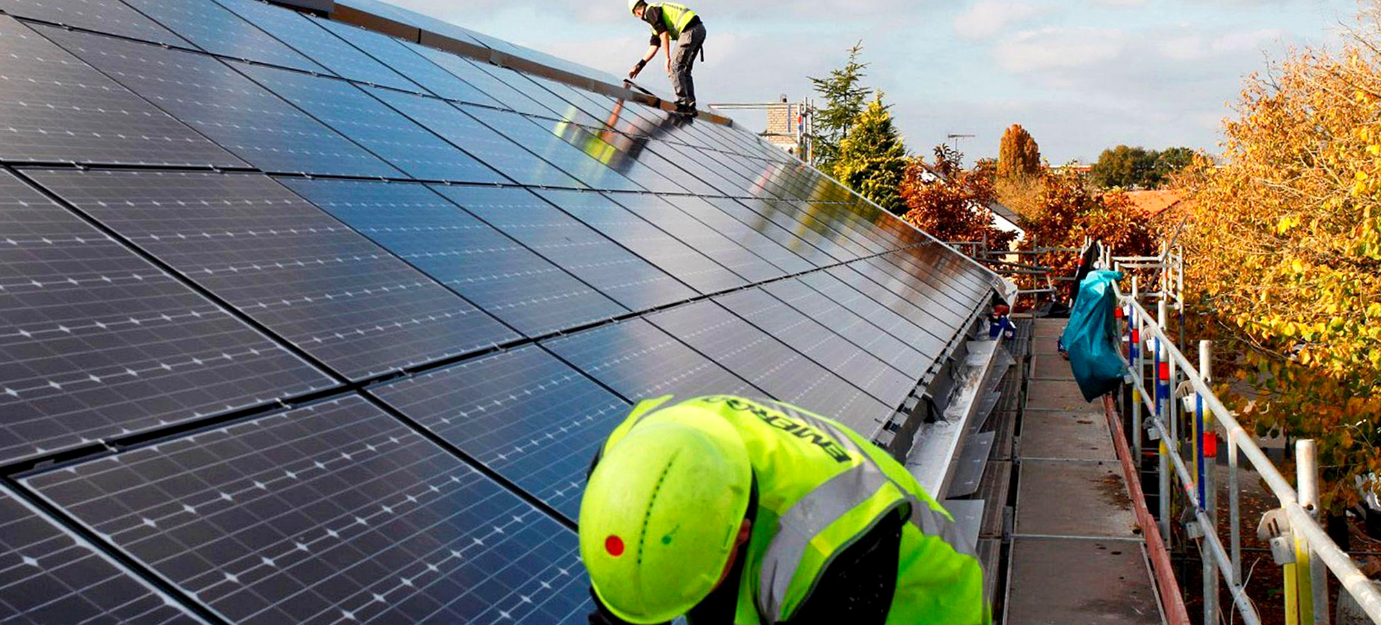 Men working on solar panels on a roof