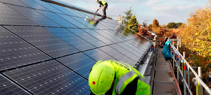 Men working on solar panels on a roof