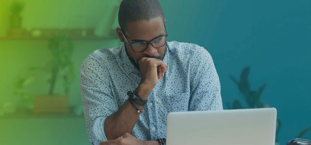 a man looking at a laptop