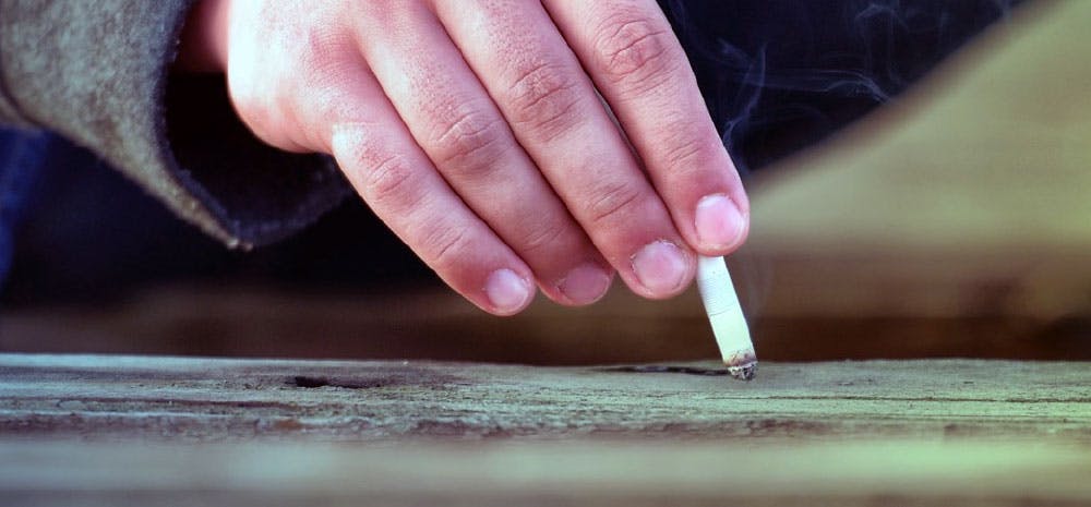 Hand putting out cigarette