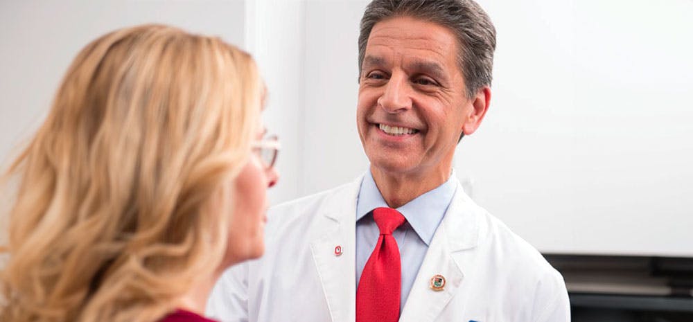 a doctor smiling at his patient