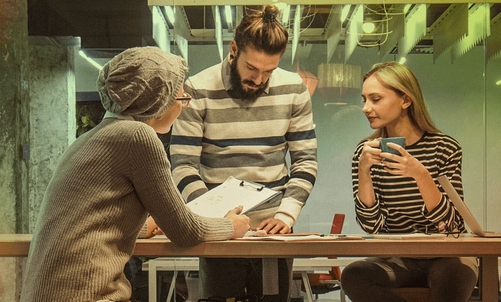 Team of people problem solving at a desk