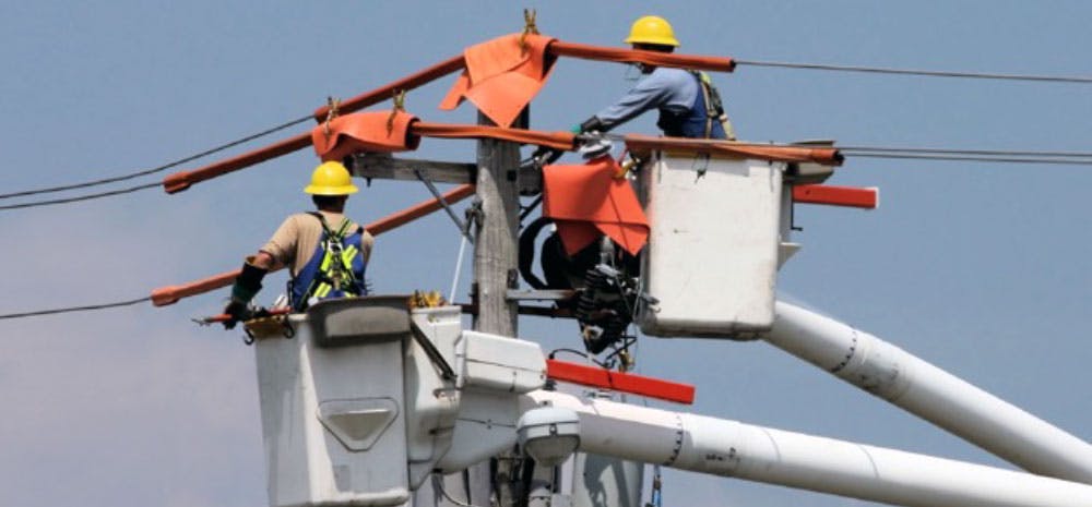 Utility company workers repairing power line