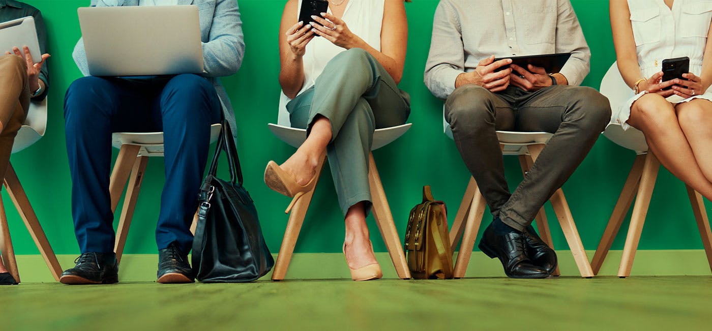 People sitting with phones, tablets and computers