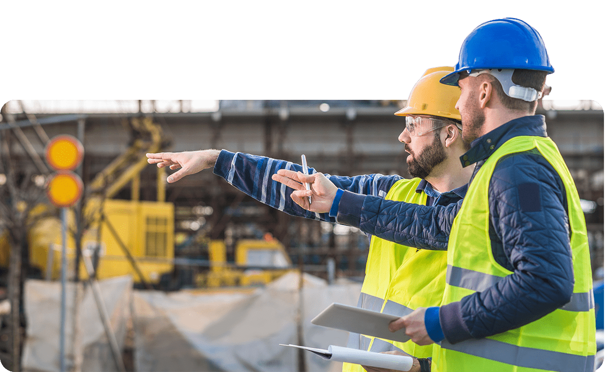 Two men working on site and pointing