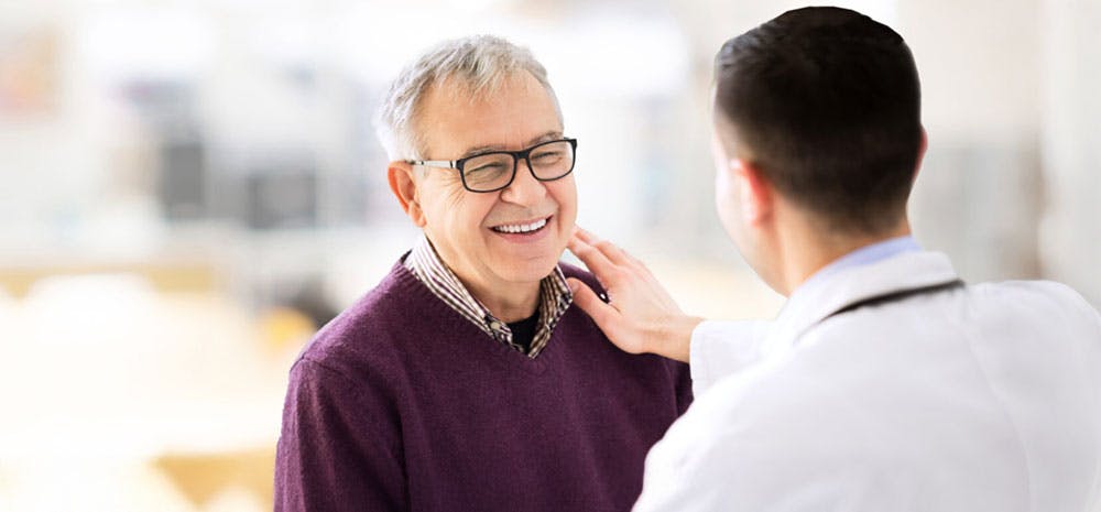 Doctor smiling with his patient