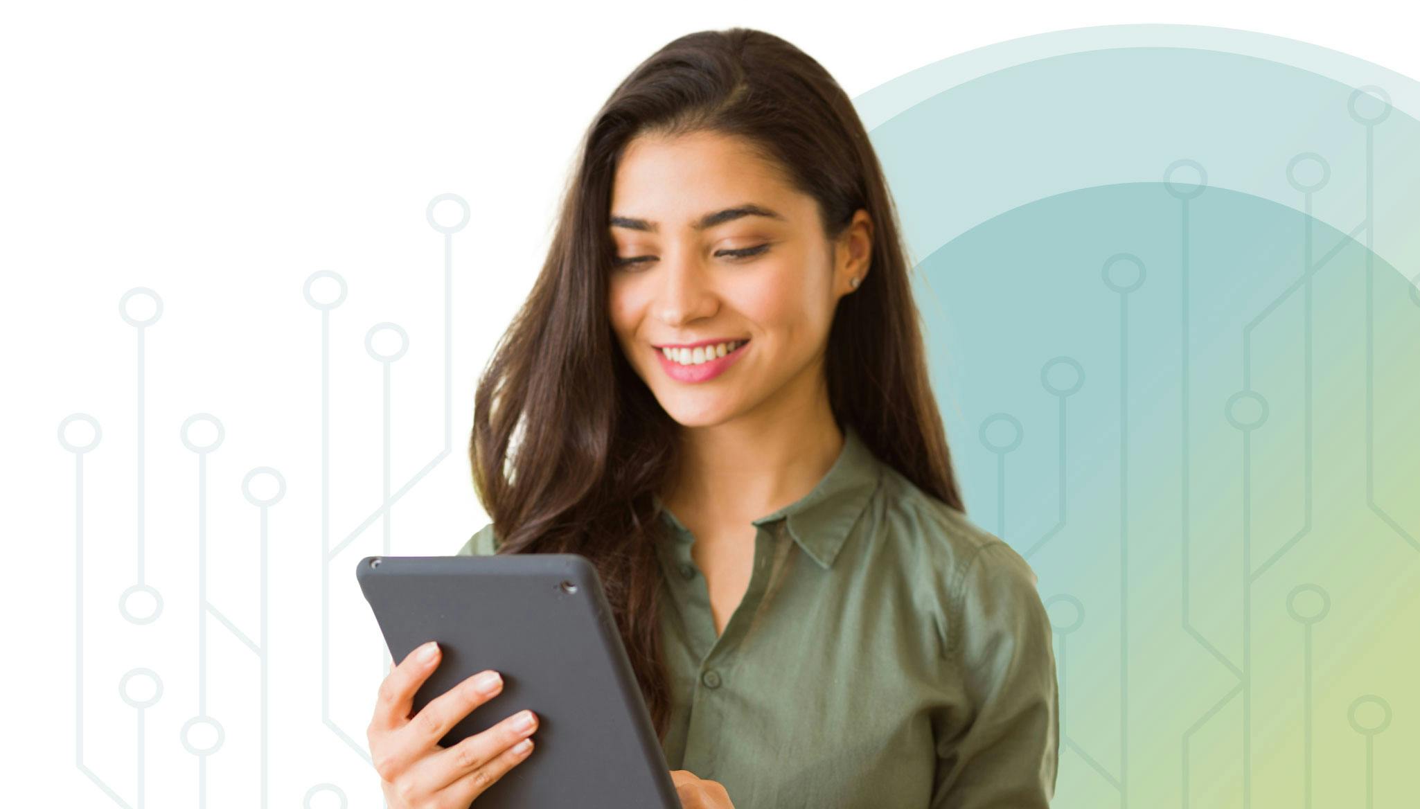 Woman looking at tablet smiling