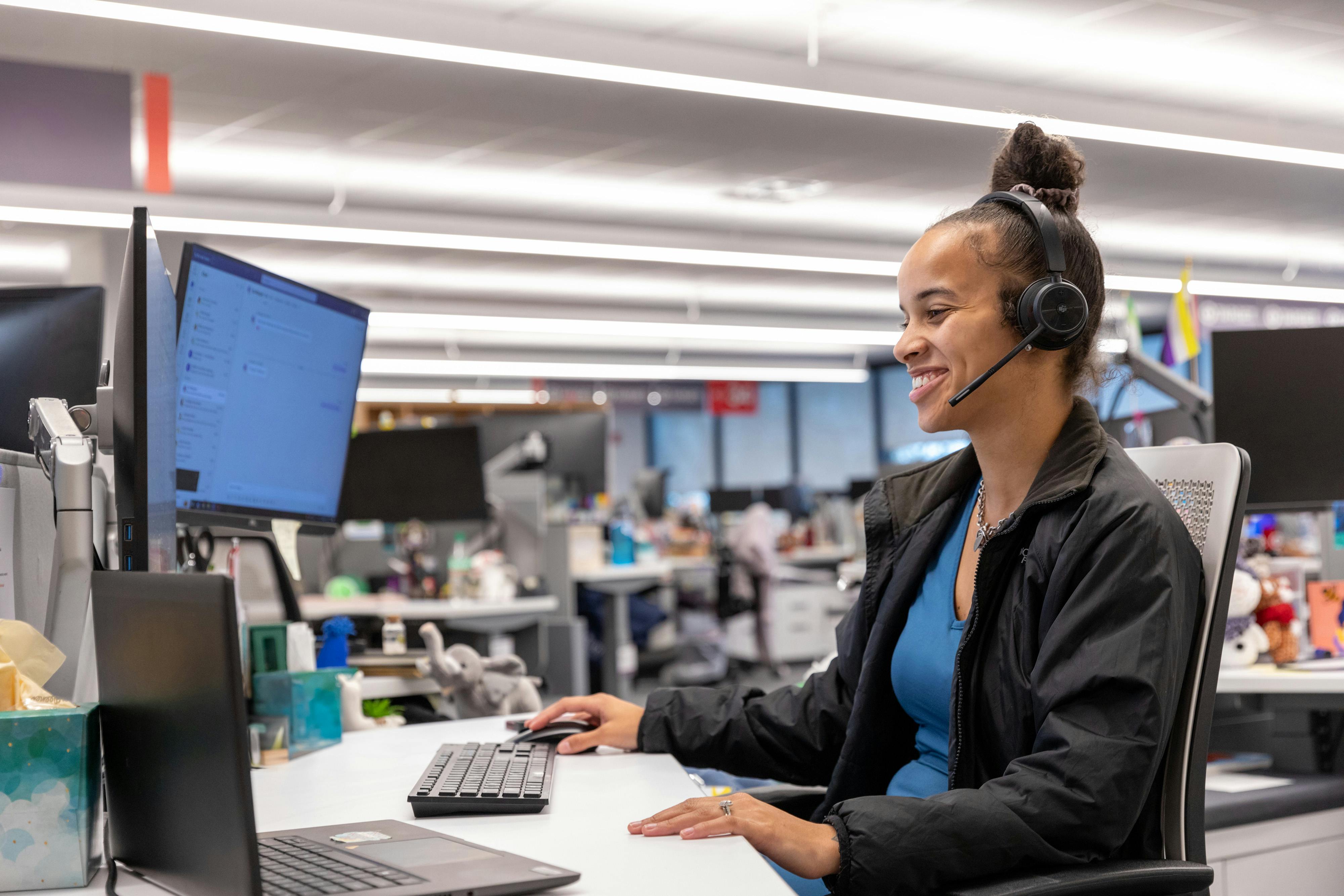 Female warrior looks at computer at desk in pod