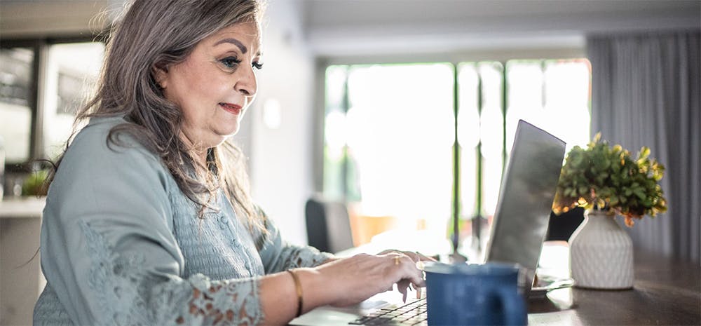 Our member, Jaunita, using her computer for benefits