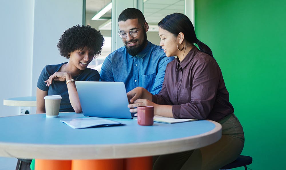 employees looking at a laptop screen