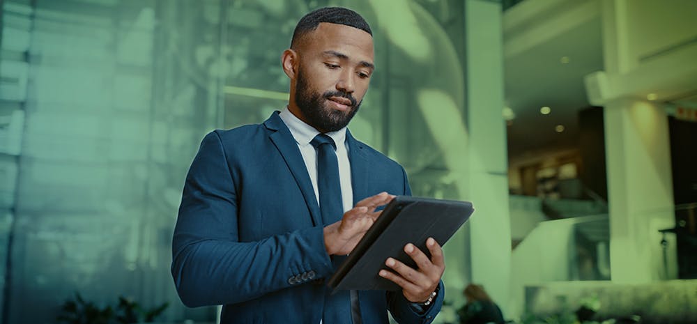 Businessman looking and pressing at a tablet.