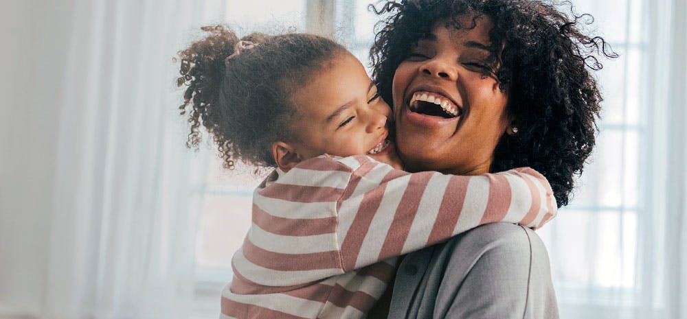 Mom and daughter smiling