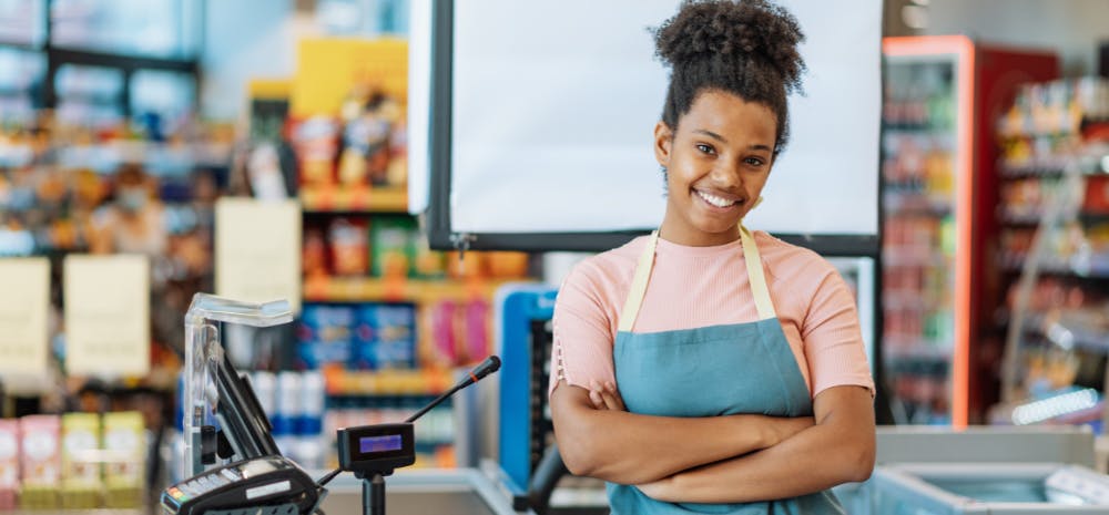 African american woman working at a cash register and smiling