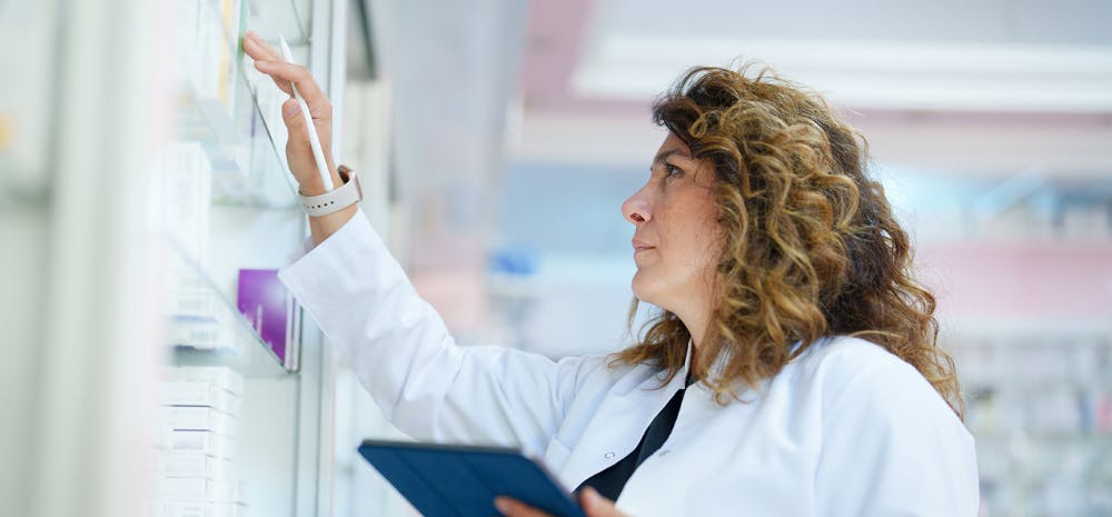 Pharmacist looks for medicine with iPad