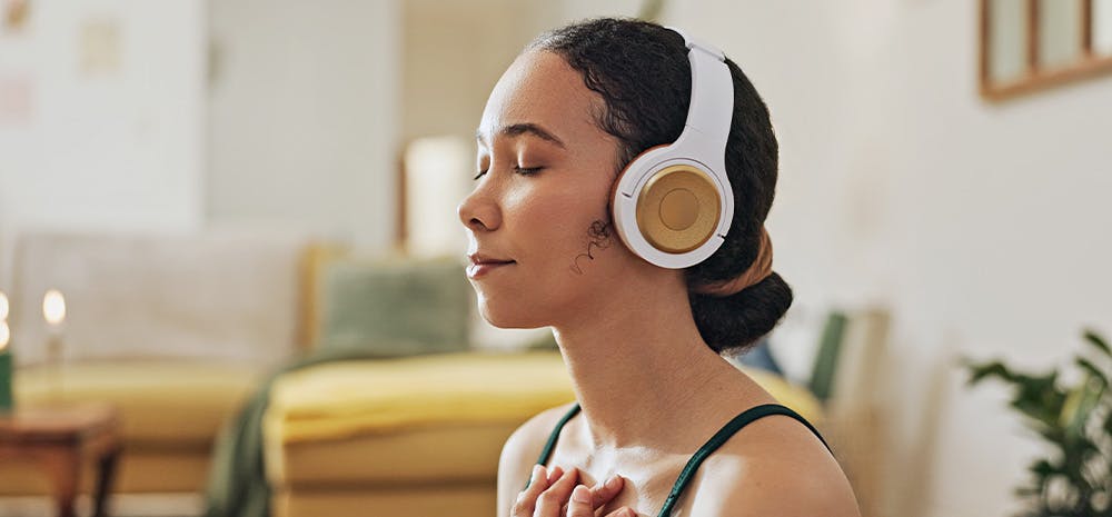 woman meditating with headphones on