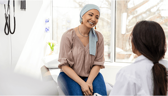woman with headwrap receiving care from a female doctor