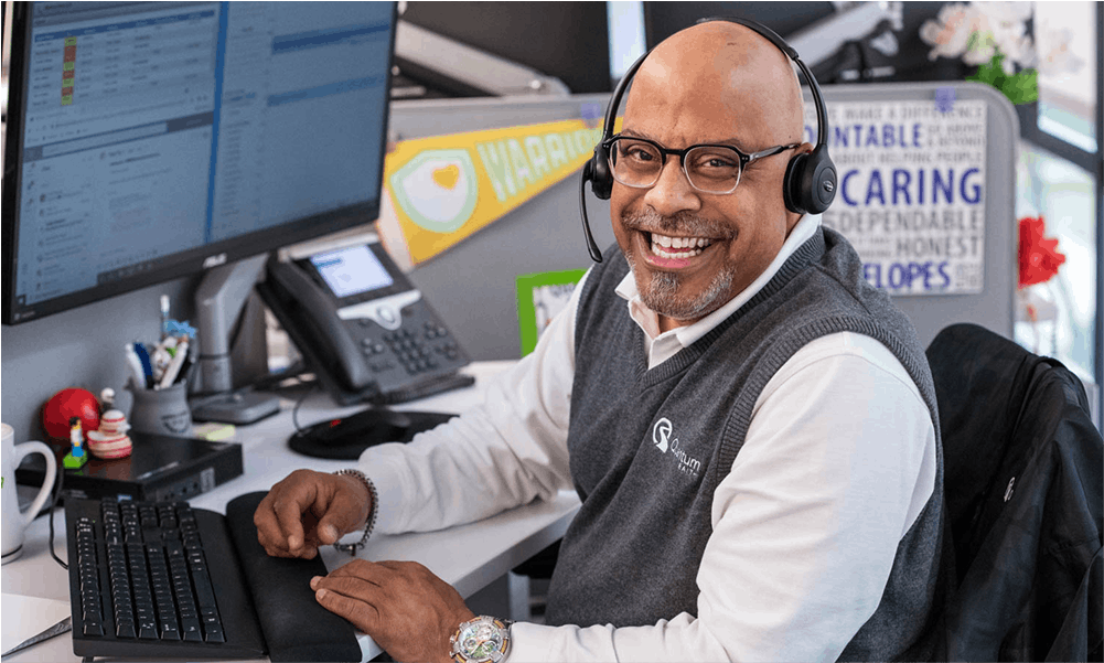 smiling man at a computer