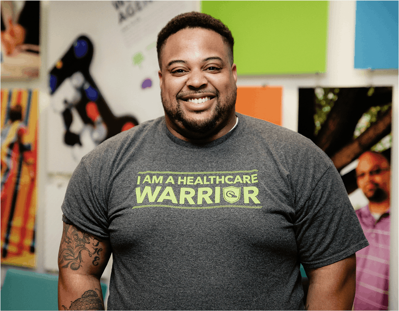 Man smiling in a Quantum Health tshirt