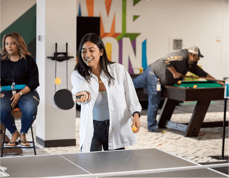 Quantum Health employee playing ping pong