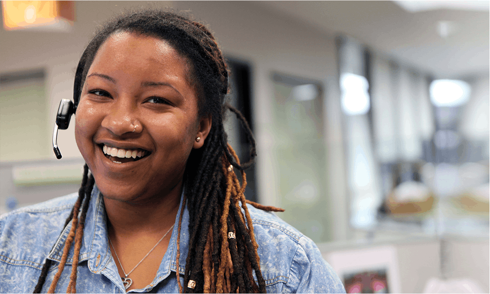 Female care coordinator smiles on headset