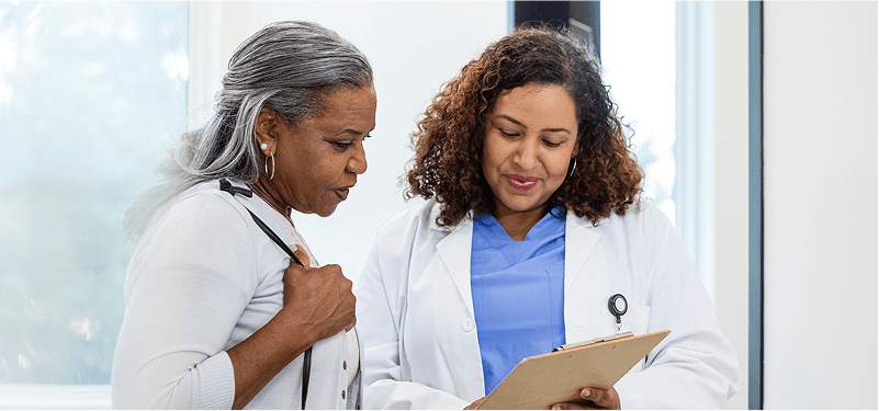 Older woman talks with doctor about test results