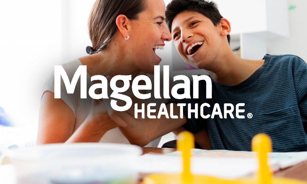 Family smiling with Magellan Healthcare logo