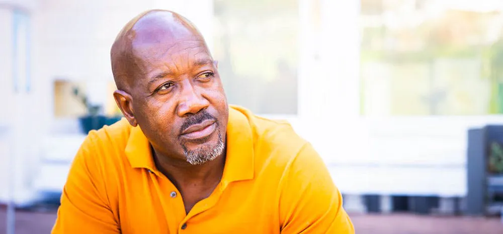 a bald man with a yellow shirt.