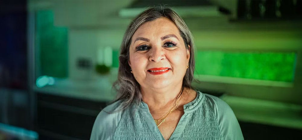 Jaunita smiling in her kitchen