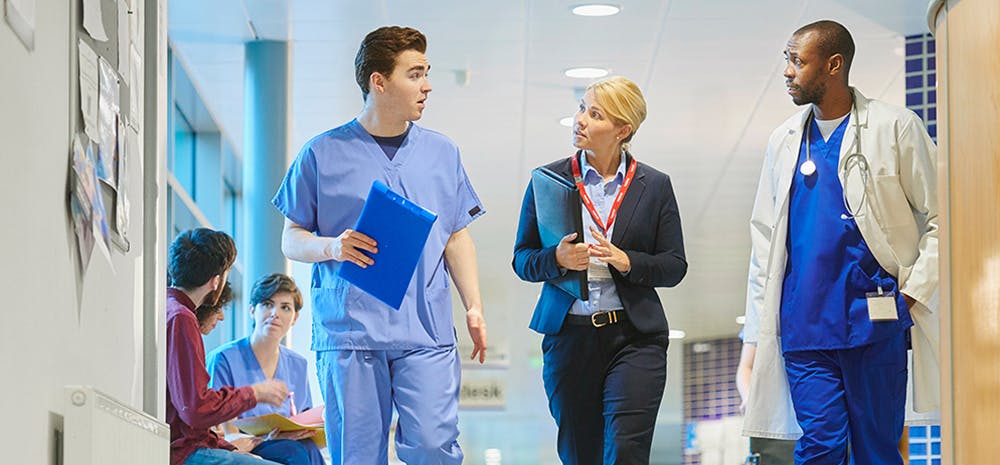 Hospital staff walking through hallway