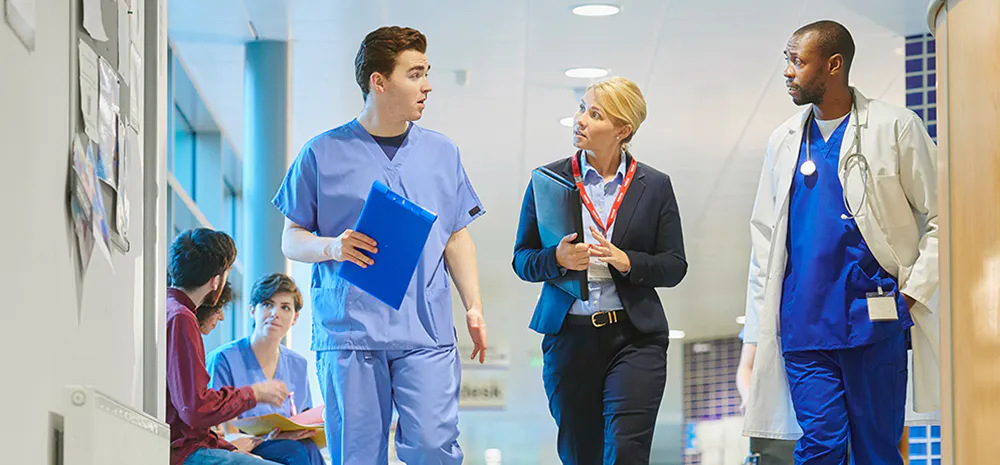 Hospital staff walking through hallway