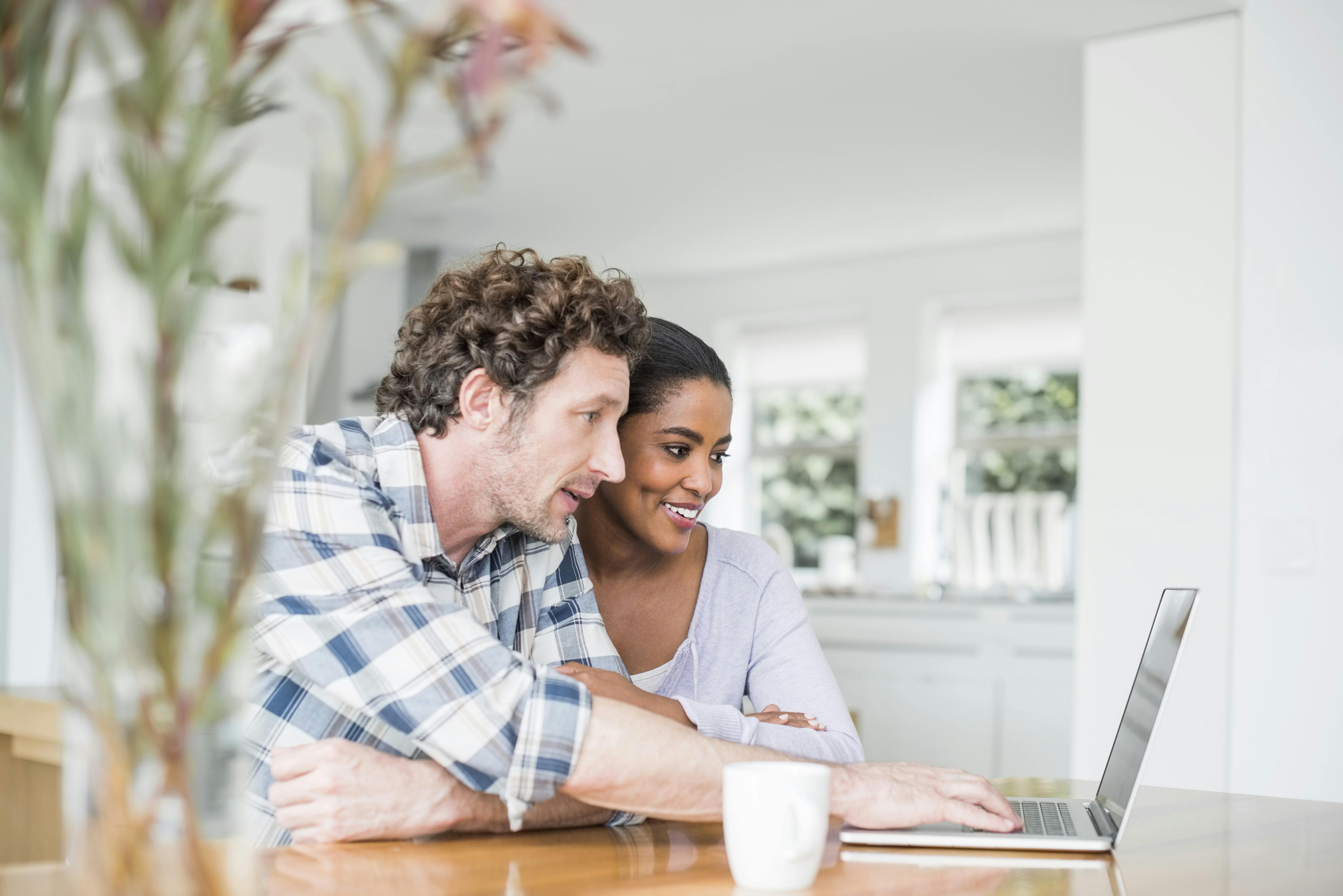Man and woman viewing laptop together