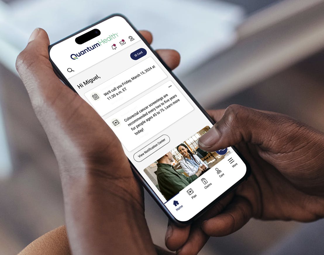 Hands holding phone with Quantum Health app on screen