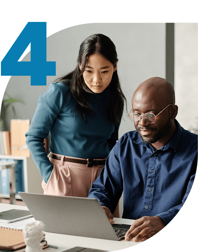 Employees looking at a laptop together