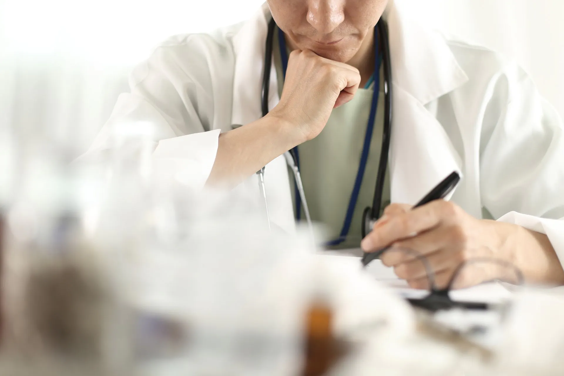 Medical professional writing patient notes.