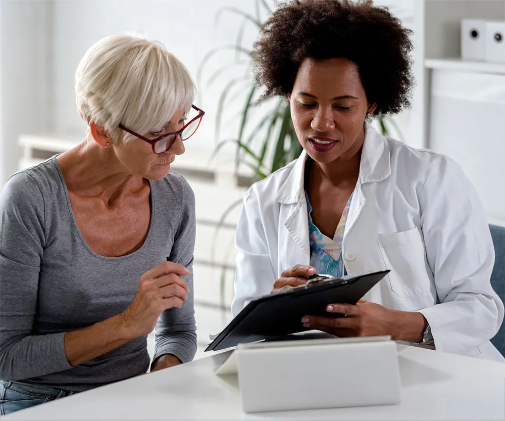 Doctor and patient looking at a clipboard