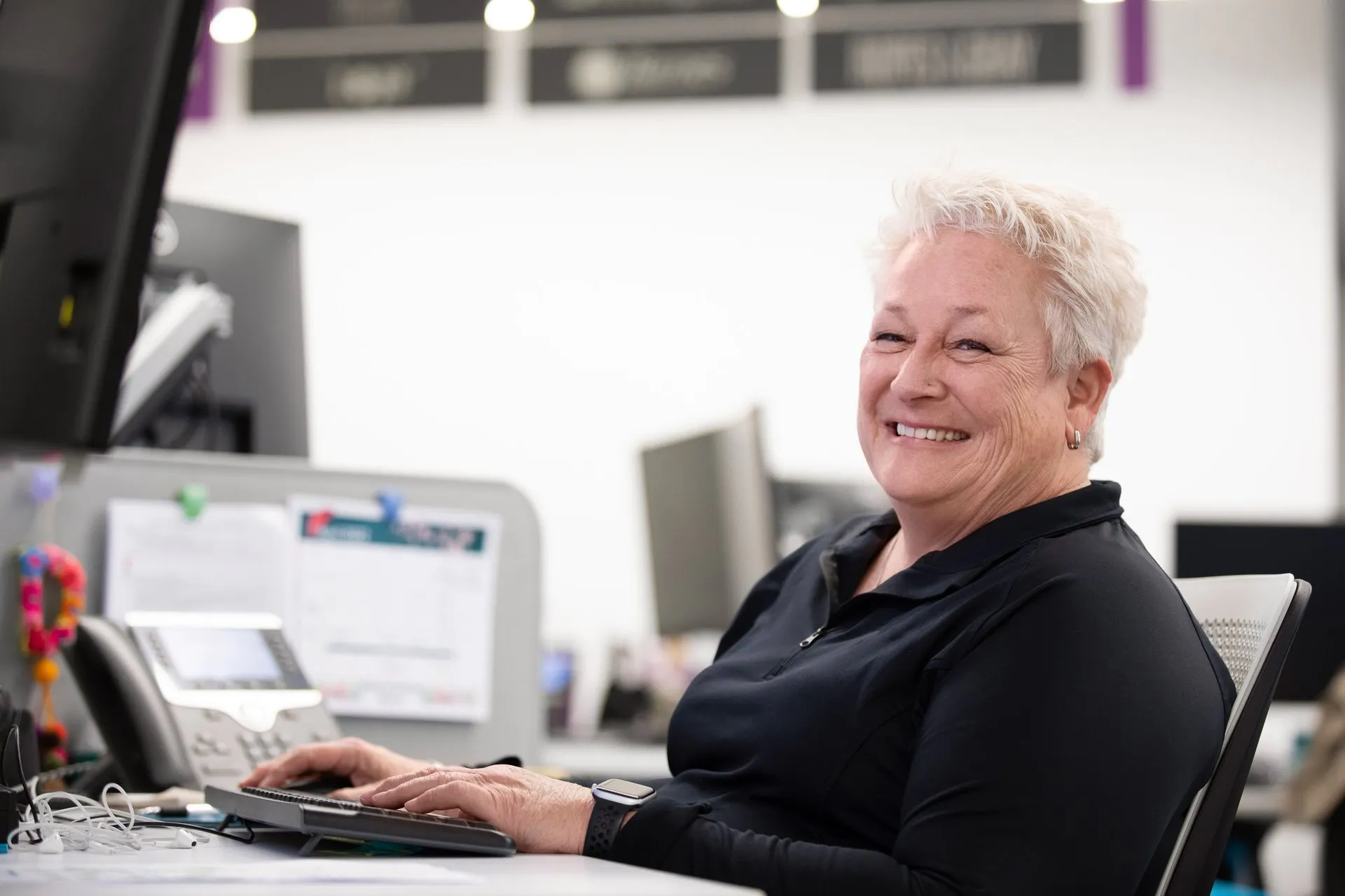 Female Warrior smiling at desk