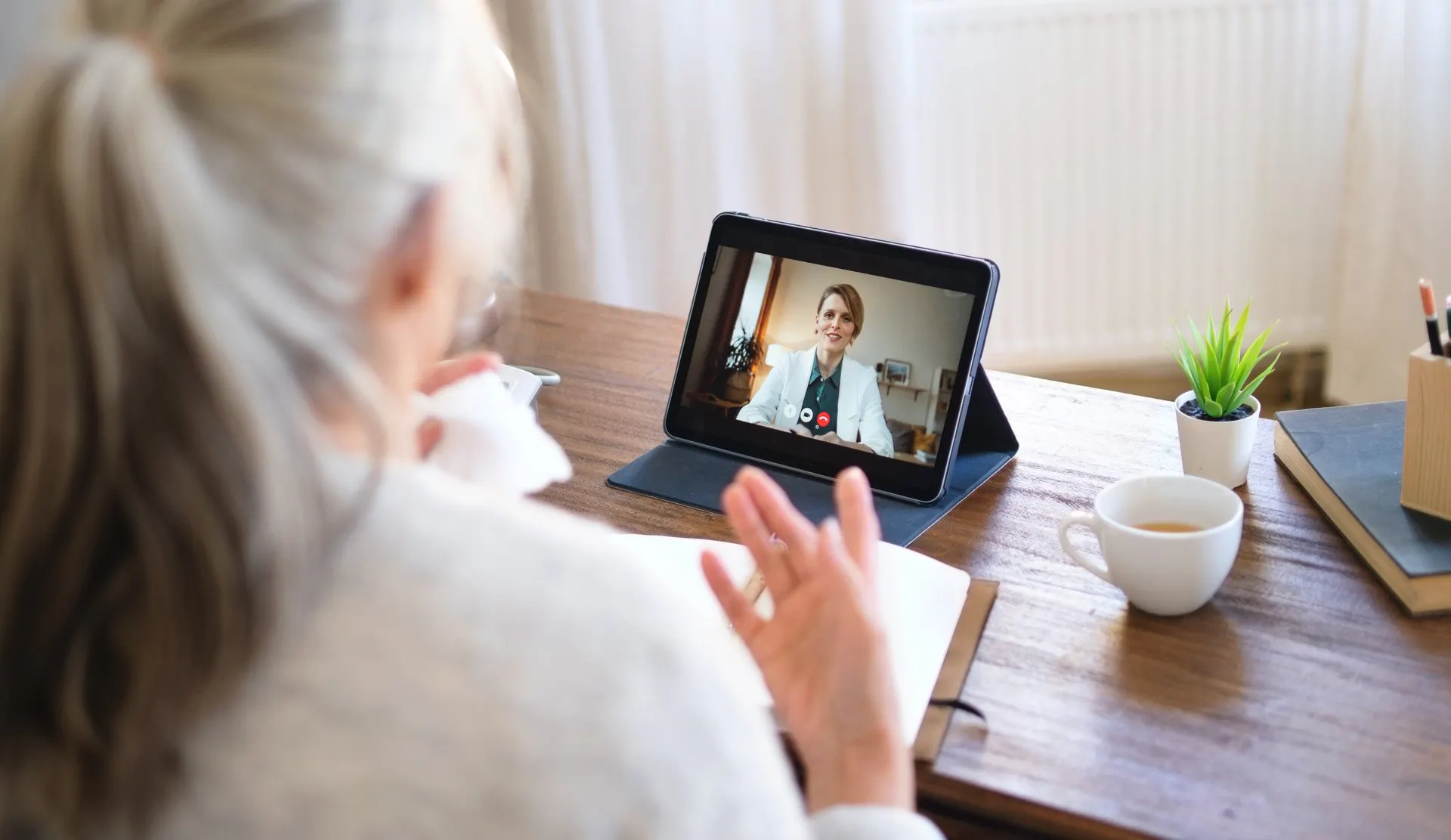 Woman talking to doctor through a digital device