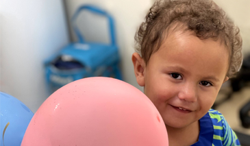 Small child with a pink balloon