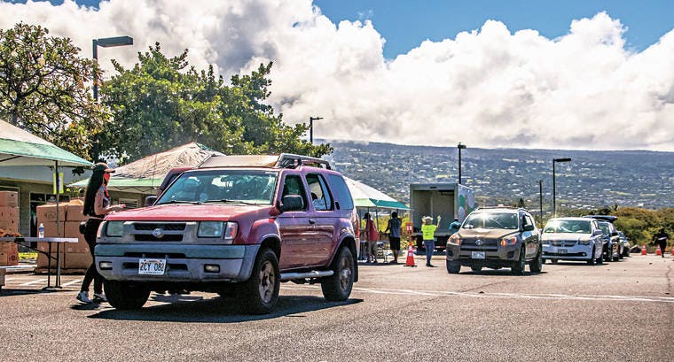 Cars line up at Old Kona Airport for The Food Basket’s Ohana Drop on Friday morning. 50,000 pounds of food were distributed to 2314 individuals. 