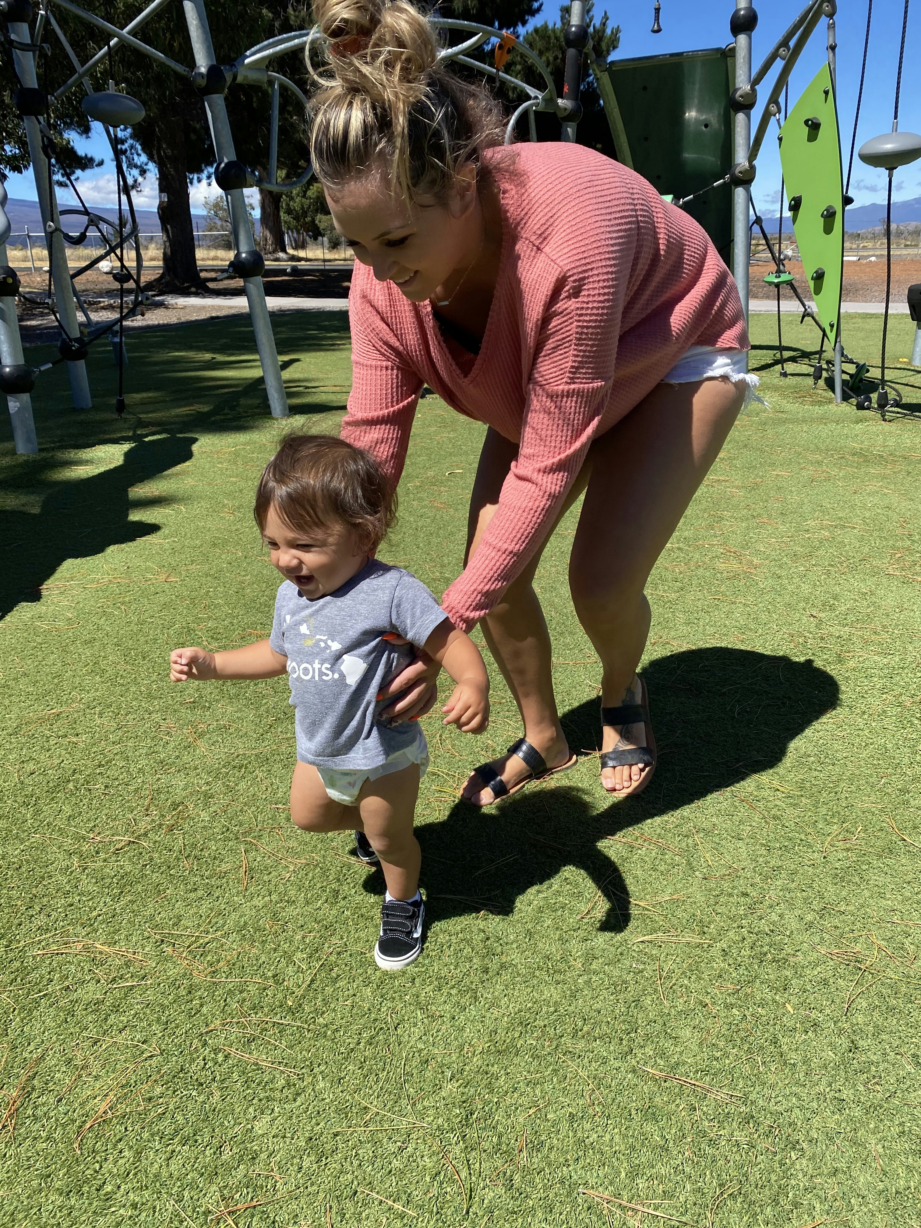 A mom chasing a child in children play area