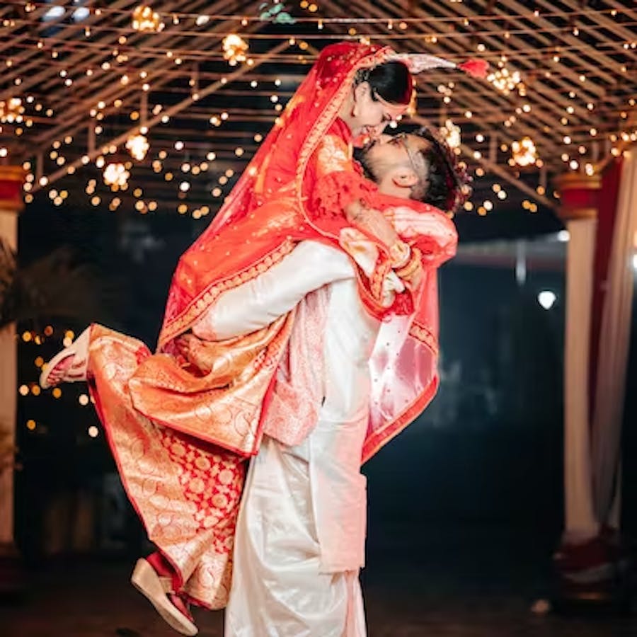Groom lifts his bride for a photo