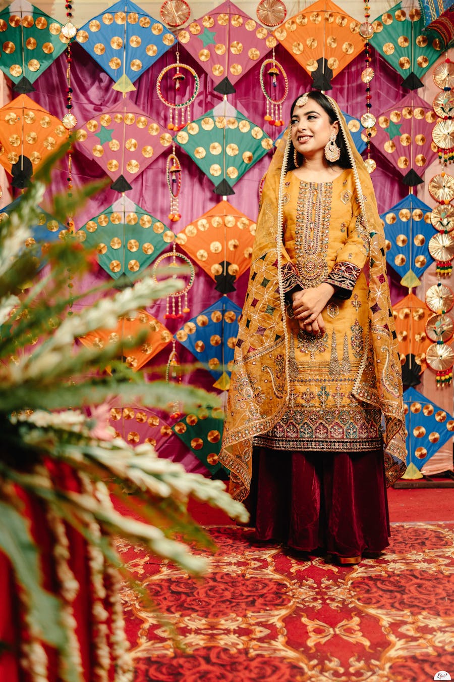 Woman standing in decorative background with veil covering her head image