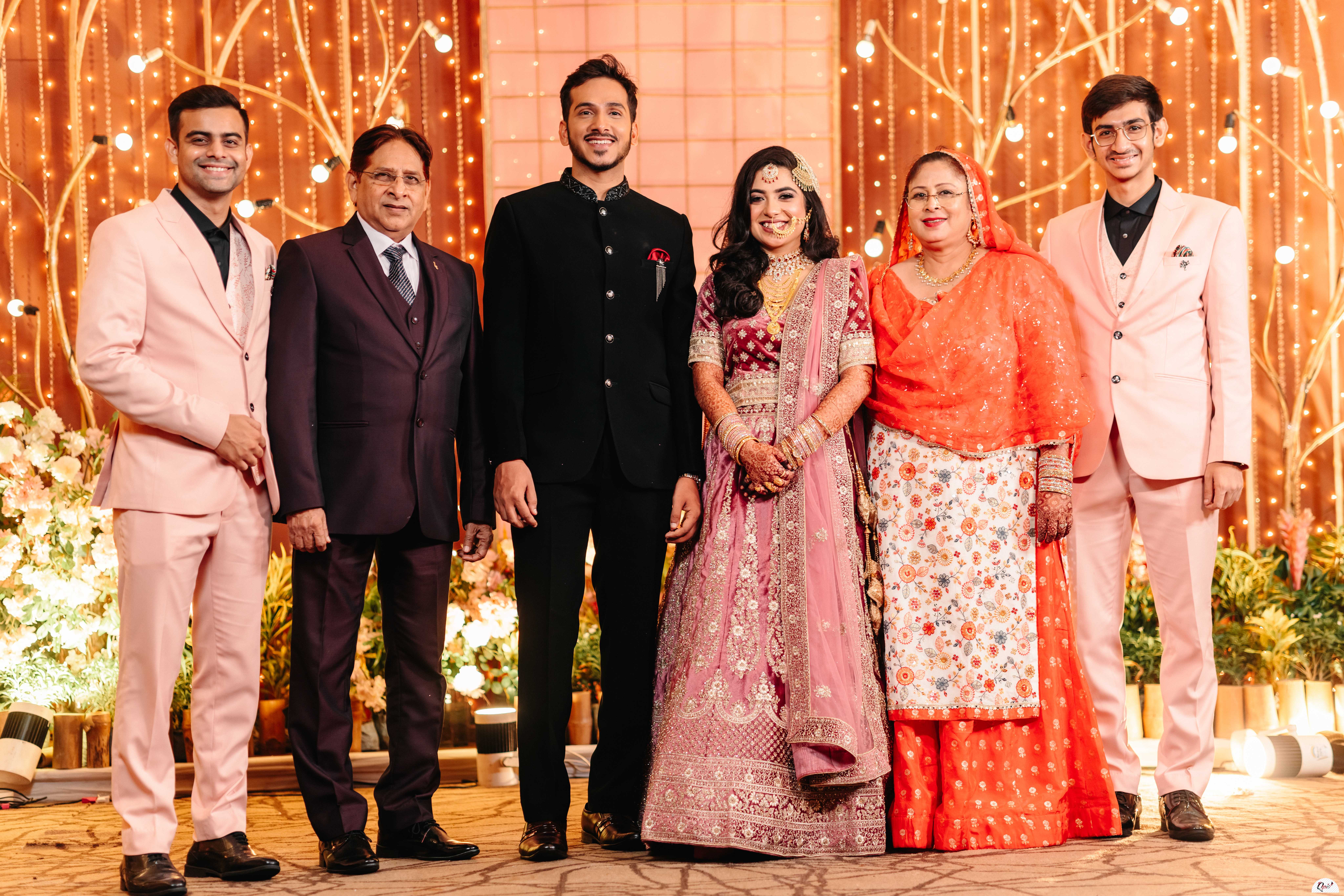 wedded couple posing for a shoot with extended family members