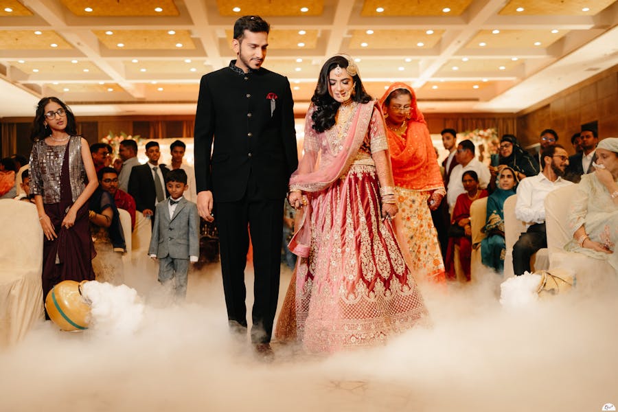 Entry pose of couple to wedding stage