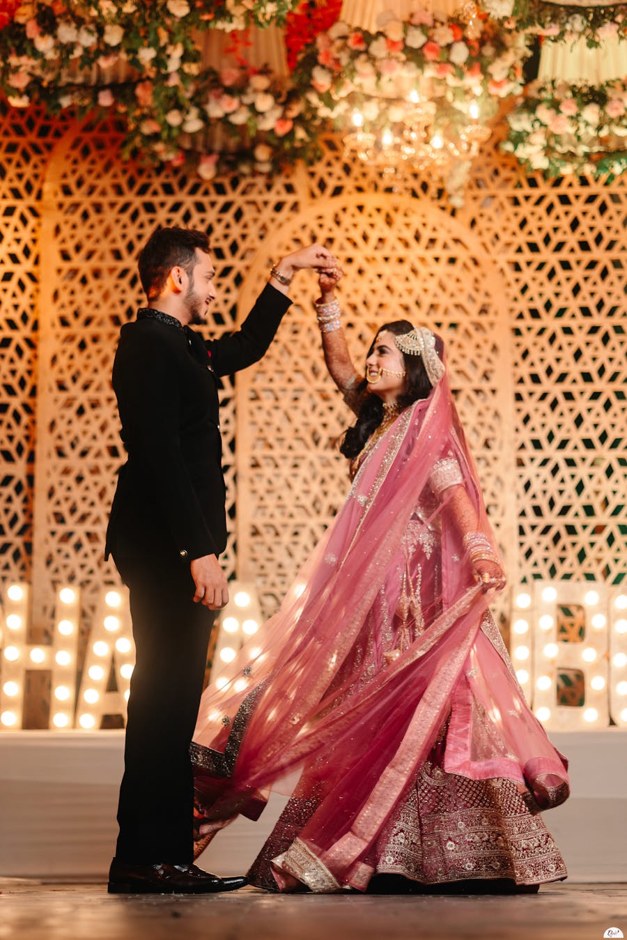 Couple candid posing happily in reception