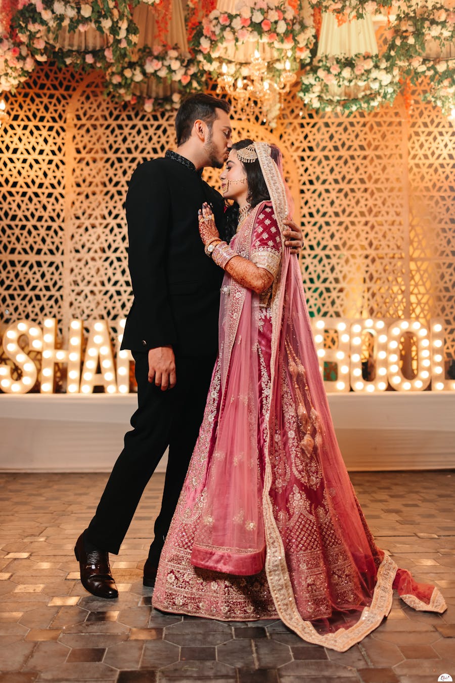 A forehead kissing pose with look-away from the camera