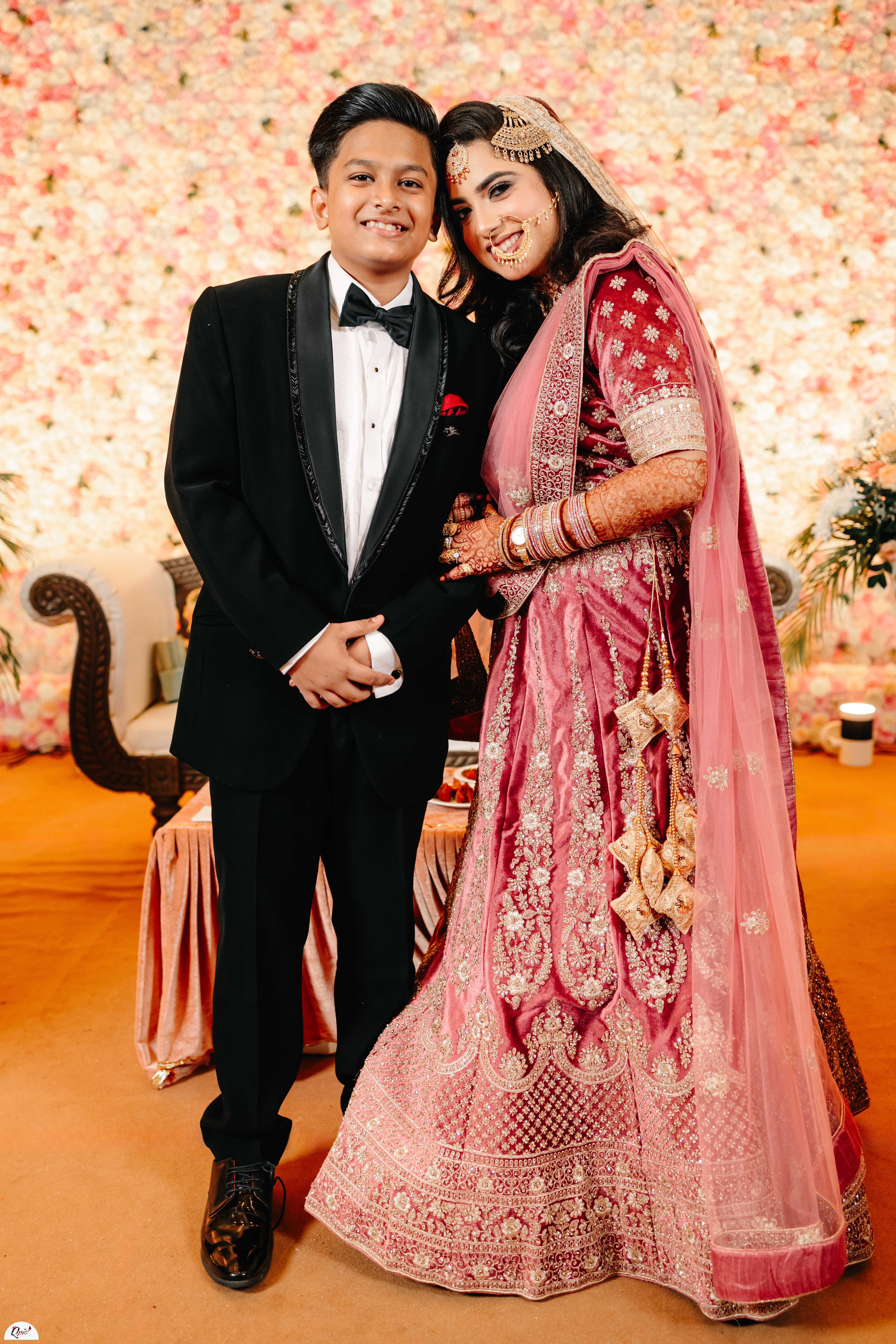 Bride posing with her younger brother